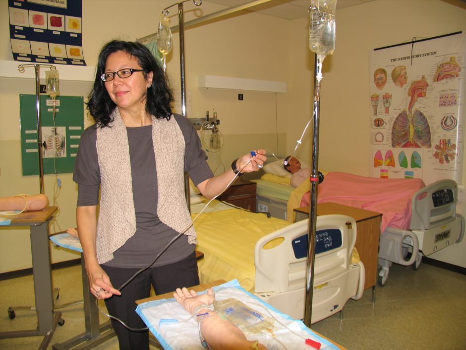 Elsie Tan demonstrates equipment in the Clinical Skills Lab.